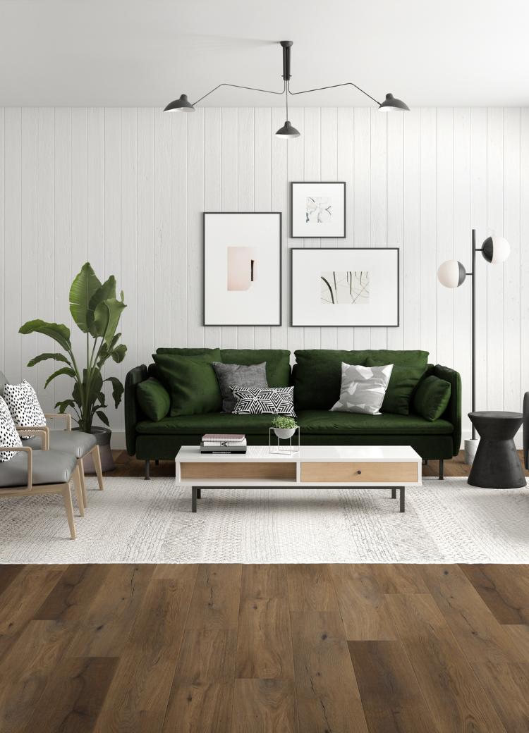 laminate flooring in living room with green couch and lighting.